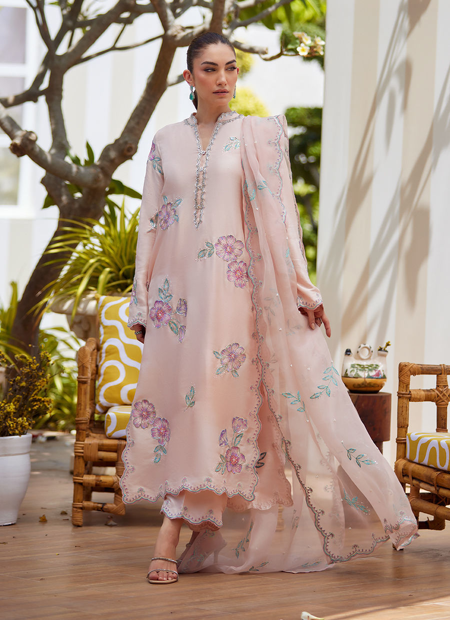 Model wearing blush pink floral embroidered dress from Farah Talib Aziz, ideal Pakistani luxury pret for summer garden parties in the UK.