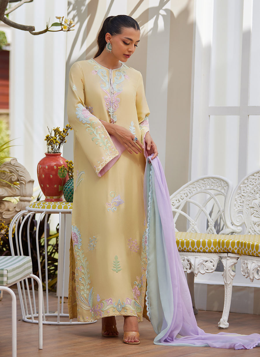 Model wearing lemon yellow embroidered dress with pastel lilac dupatta from Farah Talib Aziz, ideal for Pakistani luxury pret in the UK.