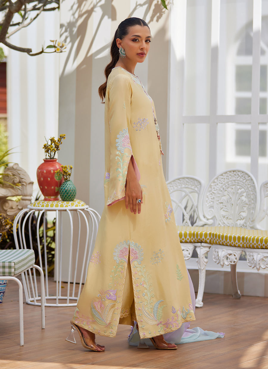Model wearing lemon yellow embroidered dress with pastel lilac dupatta from Farah Talib Aziz, ideal for Pakistani luxury pret in the UK.