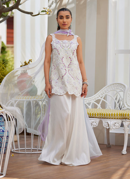 Model wearing ivory sleeveless embroidered outfit from Farah Talib Aziz, ideal for Pakistani luxury pret and Pakistani clothes online in UK.