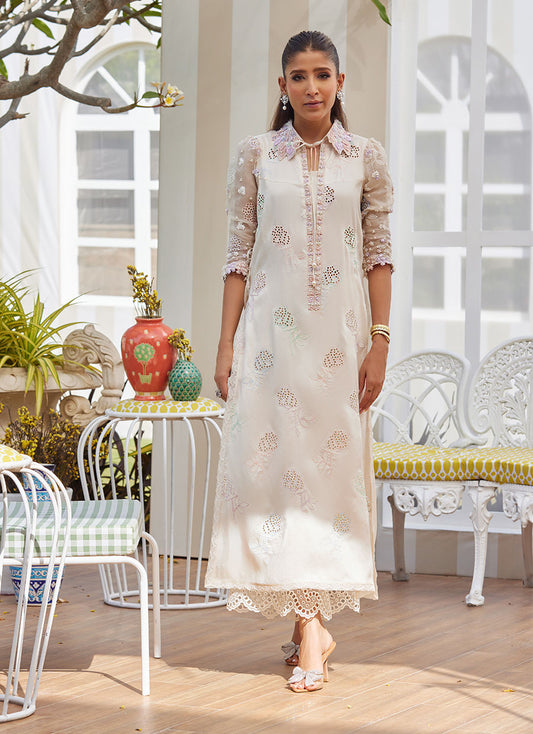 Model wearing ivory embroidered dress with pastel floral details from Farah Talib Aziz, perfect for Pakistani luxury pret in the UK.