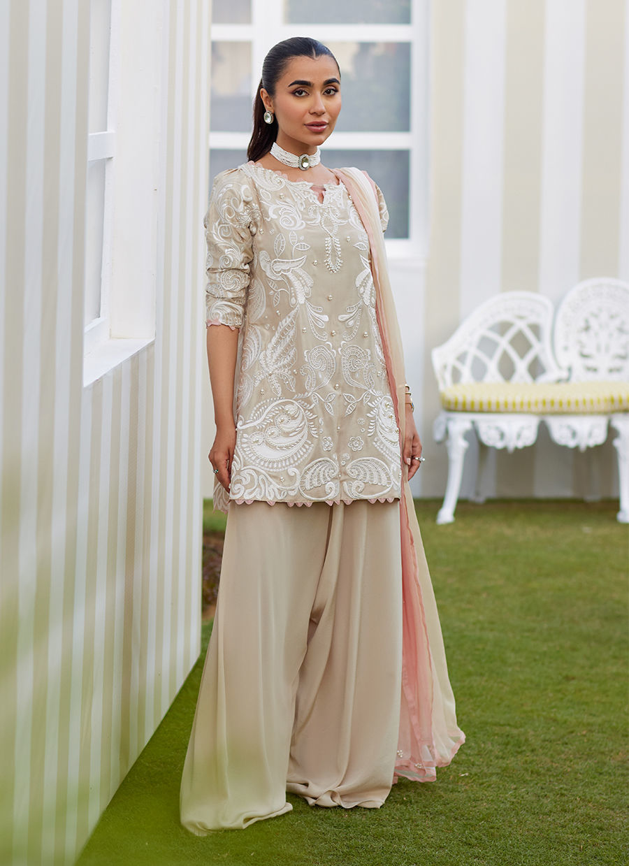 Model wearing sand Danika dress from Farah Talib Aziz, perfect for Pakistani luxury pret and Pakistani clothes online in UK.
