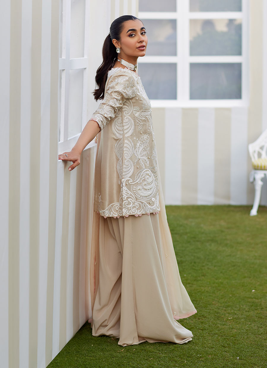 Model wearing sand Danika dress from Farah Talib Aziz, perfect for Pakistani luxury pret and Pakistani clothes online in UK.