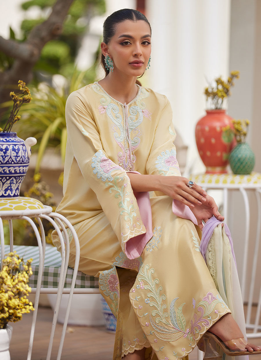 Model wearing lemon yellow embroidered dress with pastel lilac dupatta from Farah Talib Aziz, ideal for Pakistani luxury pret in the UK.