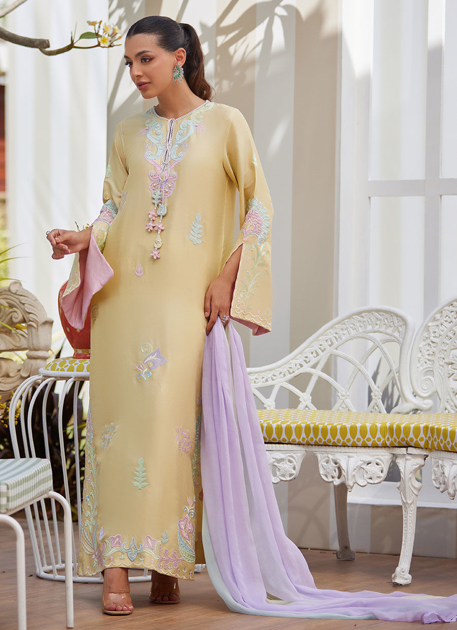 Model wearing lemon yellow embroidered dress with pastel lilac dupatta from Farah Talib Aziz, ideal for Pakistani luxury pret in the UK.