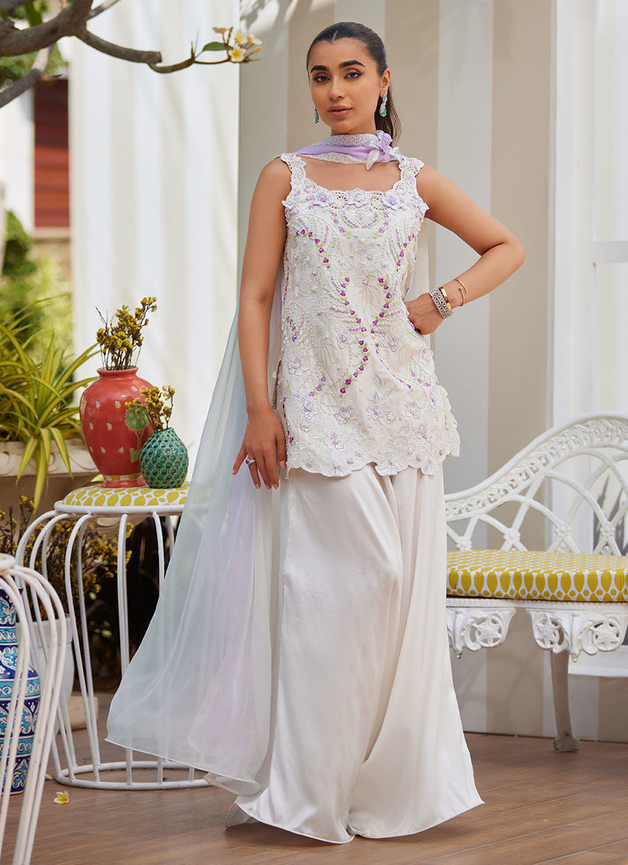 Model wearing ivory sleeveless embroidered outfit from Farah Talib Aziz, ideal for Pakistani luxury pret and Pakistani clothes online in UK.
