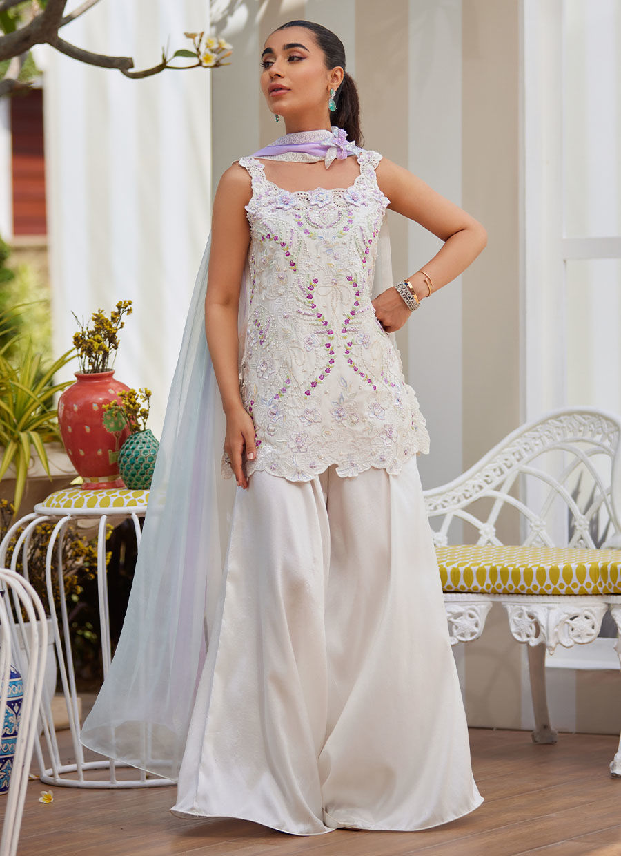 Model wearing ivory sleeveless embroidered outfit from Farah Talib Aziz, ideal for Pakistani luxury pret and Pakistani clothes online in UK.
