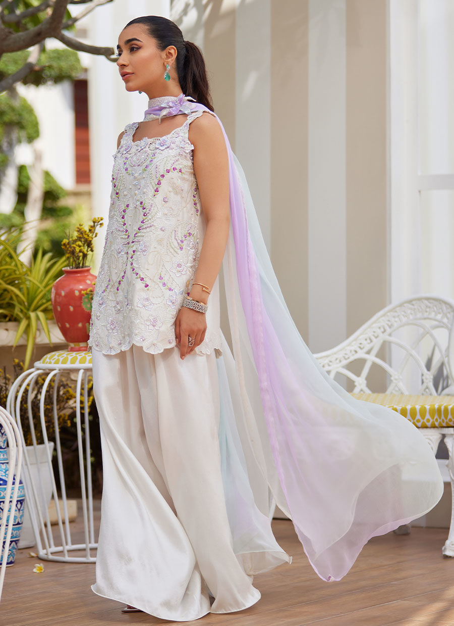 Model wearing ivory sleeveless embroidered outfit from Farah Talib Aziz, ideal for Pakistani luxury pret and Pakistani clothes online in UK.