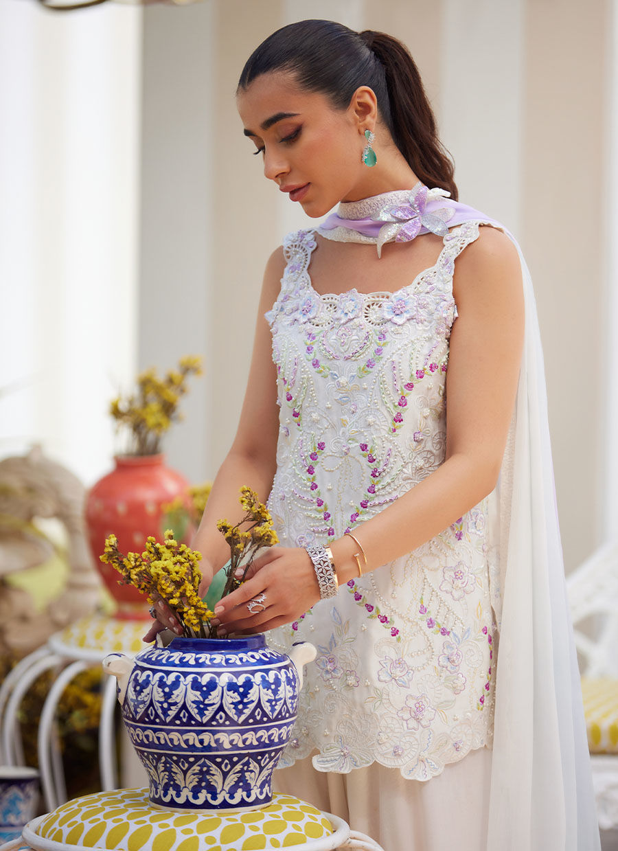 Model wearing ivory sleeveless embroidered outfit from Farah Talib Aziz, ideal for Pakistani luxury pret and Pakistani clothes online in UK.