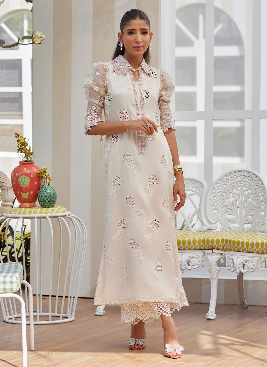 Model wearing ivory embroidered dress with pastel floral details from Farah Talib Aziz, perfect for Pakistani luxury pret in the UK.