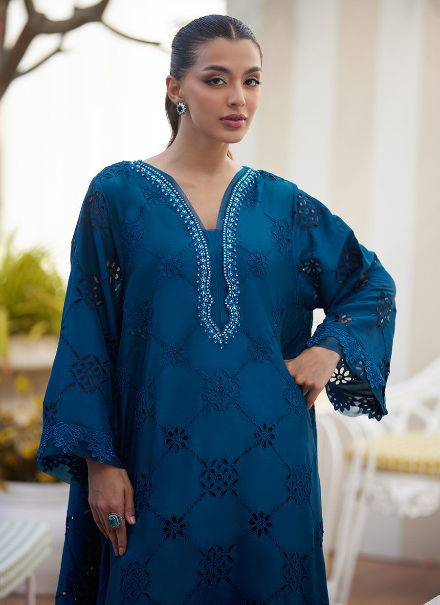 Model wearing teal blue embroidered dress with mirror detailing from Farah Talib Aziz, perfect for Pakistani luxury pret online in UK.