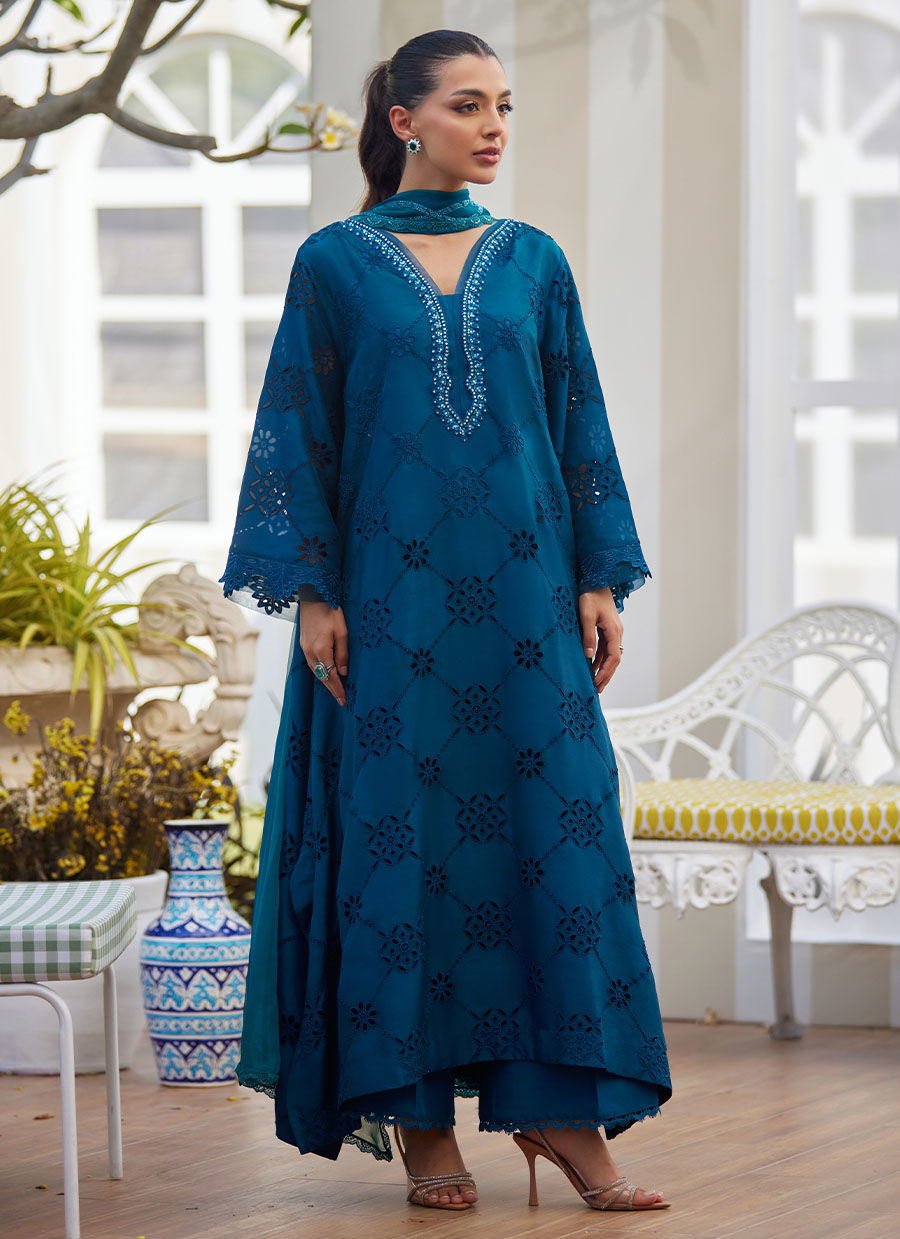 Model wearing teal blue embroidered dress with mirror detailing from Farah Talib Aziz, perfect for Pakistani luxury pret online in UK.