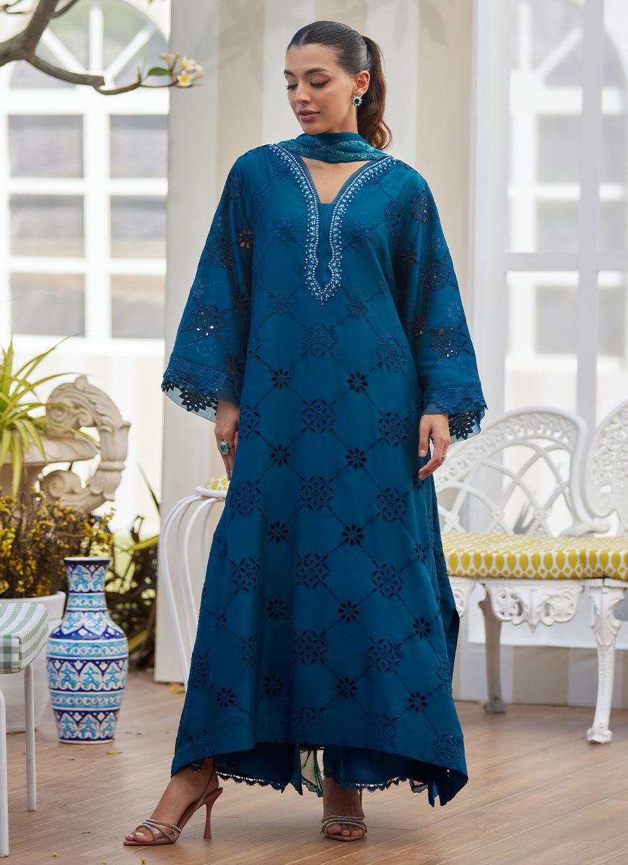 Model wearing teal blue embroidered dress with mirror detailing from Farah Talib Aziz, perfect for Pakistani luxury pret online in UK.