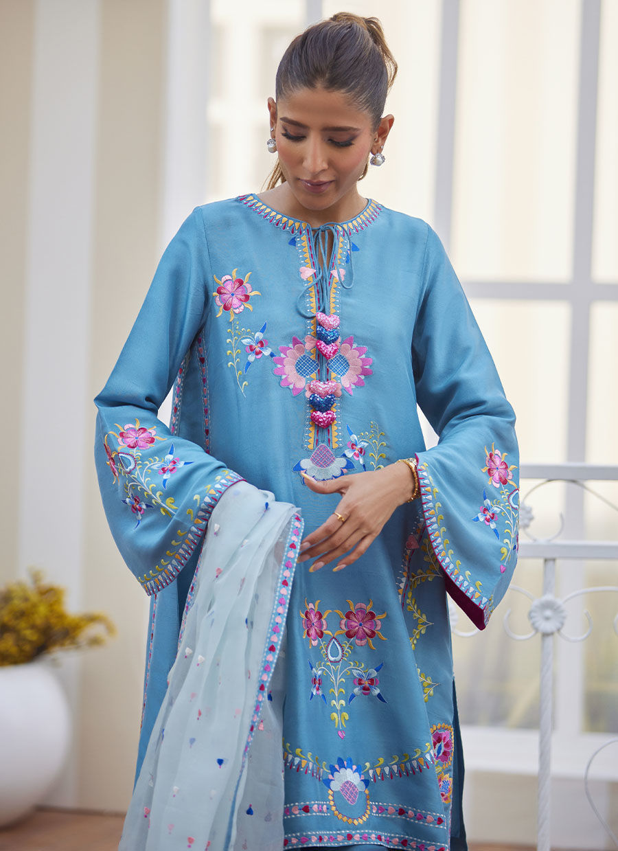Model wearing sky blue embroidered outfit from Farah Talib Aziz, perfect for Pakistani luxury pret and Pakistani clothes online in UK.