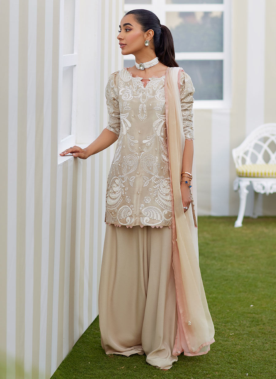 Model wearing sand Danika dress from Farah Talib Aziz, perfect for Pakistani luxury pret and Pakistani clothes online in UK.