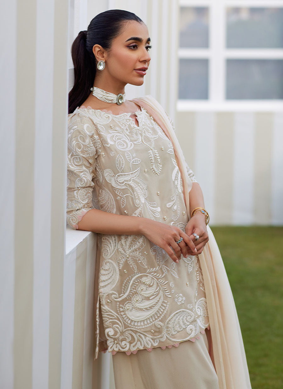 Model wearing sand Danika dress from Farah Talib Aziz, perfect for Pakistani luxury pret and Pakistani clothes online in UK.