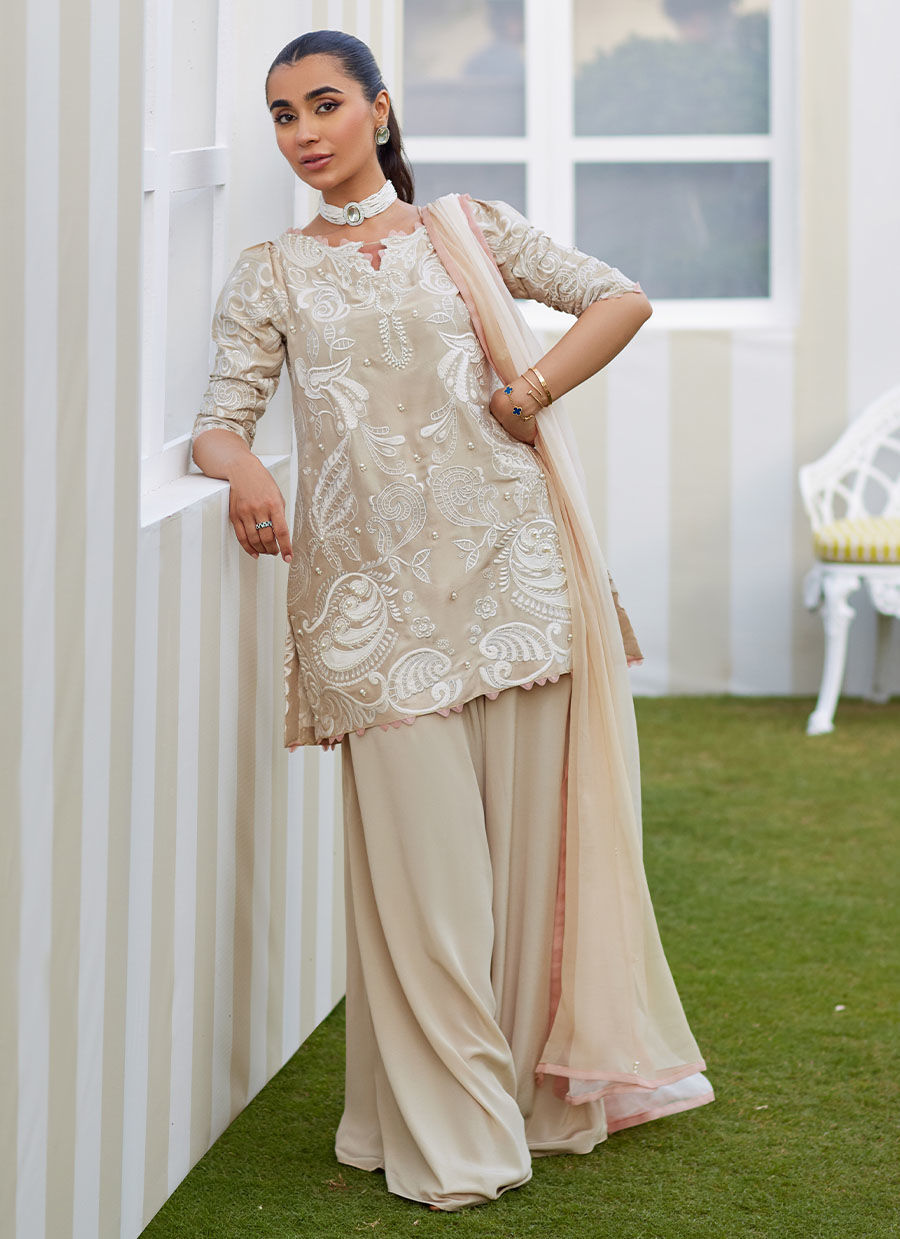 Model wearing sand Danika dress from Farah Talib Aziz, perfect for Pakistani luxury pret and Pakistani clothes online in UK.