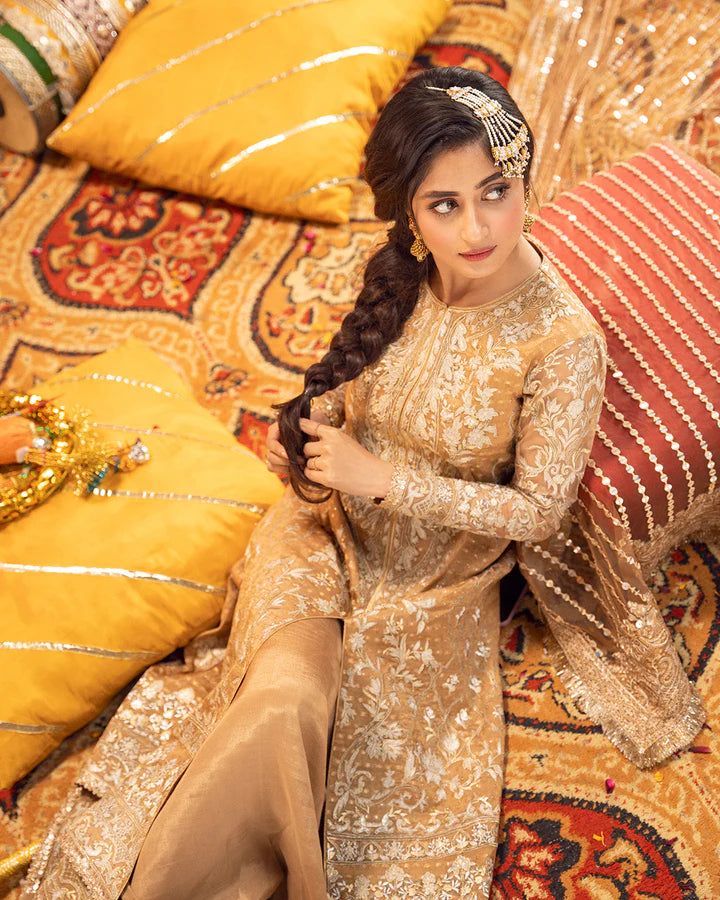 model wearing beige dress by Faiza Saqlain, Pakistani luxury pret ideal for online shopping in the UK