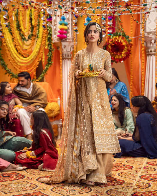 model wearing beige dress by Faiza Saqlain, Pakistani luxury pret ideal for online shopping in the UK