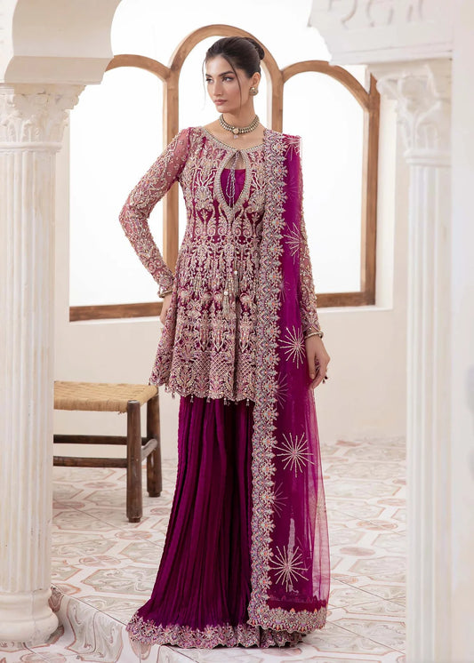 Model wearing deep magenta Kaira dress by Kanwal Malik, adorned with rich embroidery—Pakistani luxury pret available online in UK.
