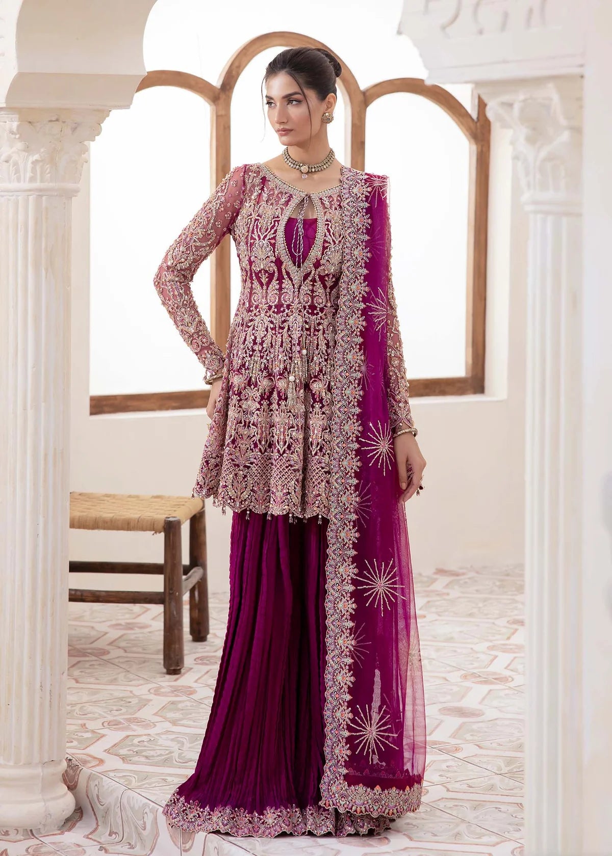 Model wearing deep magenta Kaira dress by Kanwal Malik, adorned with rich embroidery—Pakistani luxury pret available online in UK.