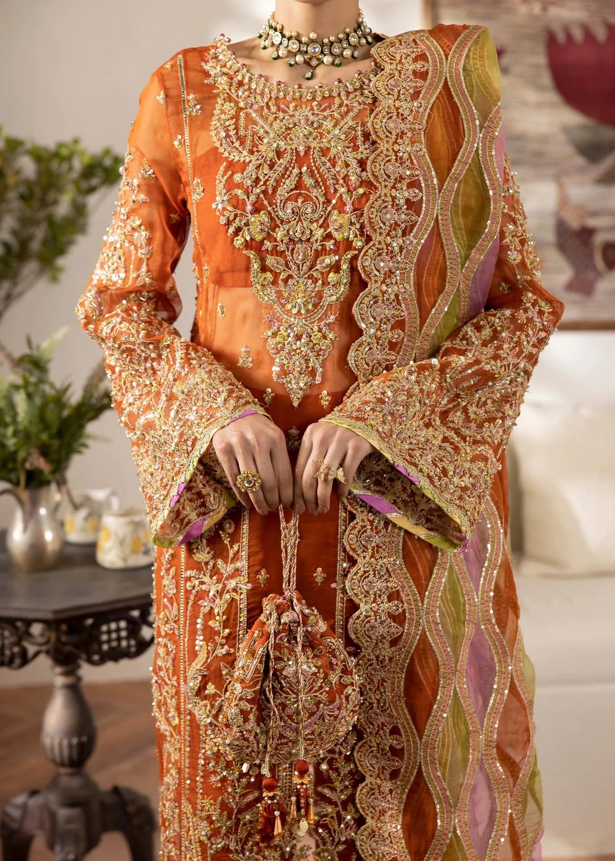 Model wearing burnt orange Roshail dress by Kanwal Malik with detailed embroidery—Pakistani luxury pret available online in UK.