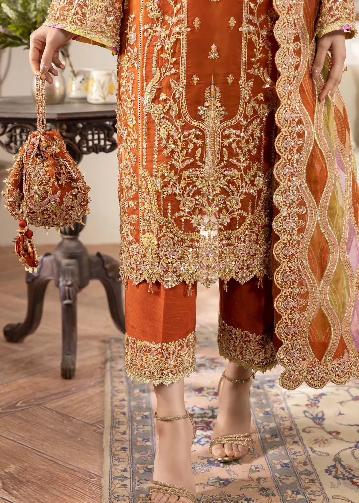 Model wearing burnt orange Roshail dress by Kanwal Malik with detailed embroidery—Pakistani luxury pret available online in UK.