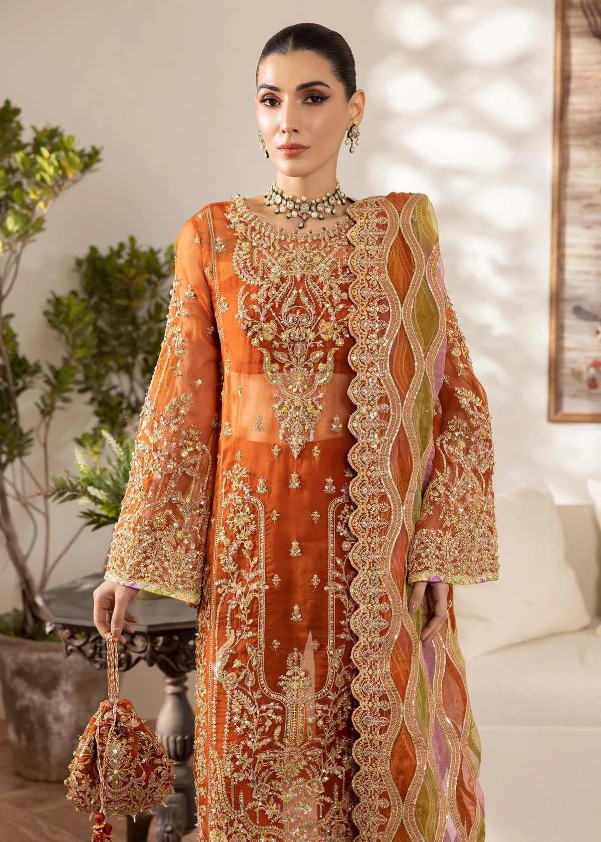Model wearing burnt orange Roshail dress by Kanwal Malik with detailed embroidery—Pakistani luxury pret available online in UK.