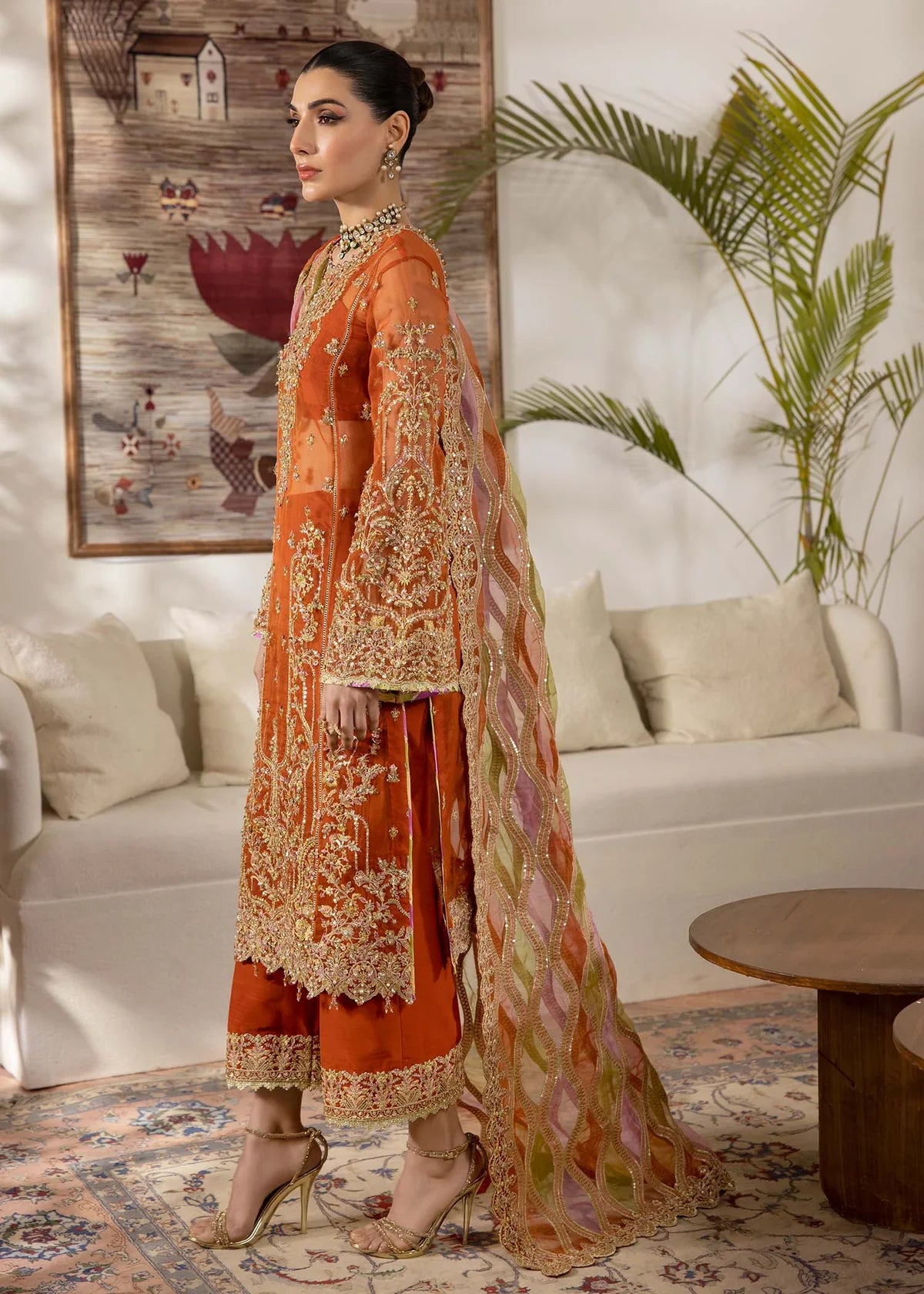 Model wearing burnt orange Roshail dress by Kanwal Malik with detailed embroidery—Pakistani luxury pret available online in UK.