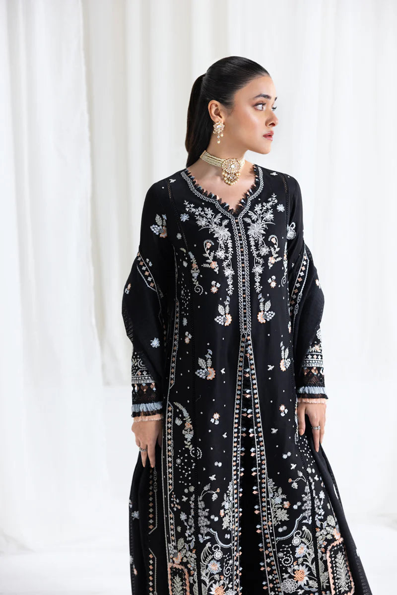 Model wearing black Qalamkar SB-03 Misha embroidered suit with peach accents, ideal for Eid and Pakistani luxury pret online in UK.