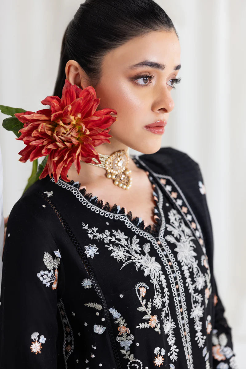 Model wearing black Qalamkar SB-03 Misha embroidered suit with peach accents, ideal for Eid and Pakistani luxury pret online in UK.
