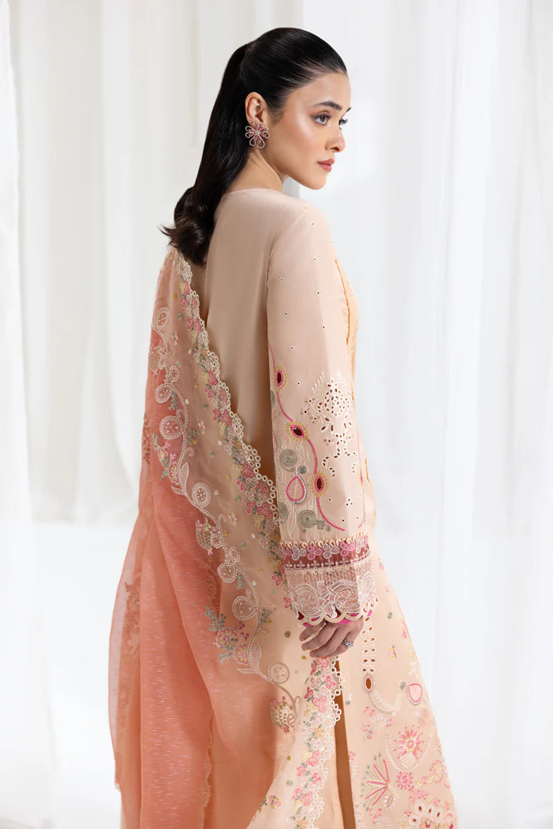 Model wearing peach Qalamkar SB-07 Zoya embroidered suit with floral detailing, perfect for Eid and Pakistani luxury pret online in UK.