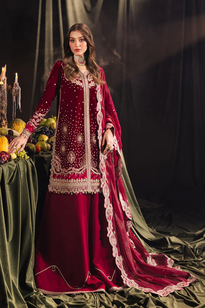 Model wearing Qalamkar Velvet Edit '24 BK-02 AMARA, a luxurious deep red velvet dress adorned with intricate embroidery, perfect for weddings. Available as Pakistani clothes online in the UK.