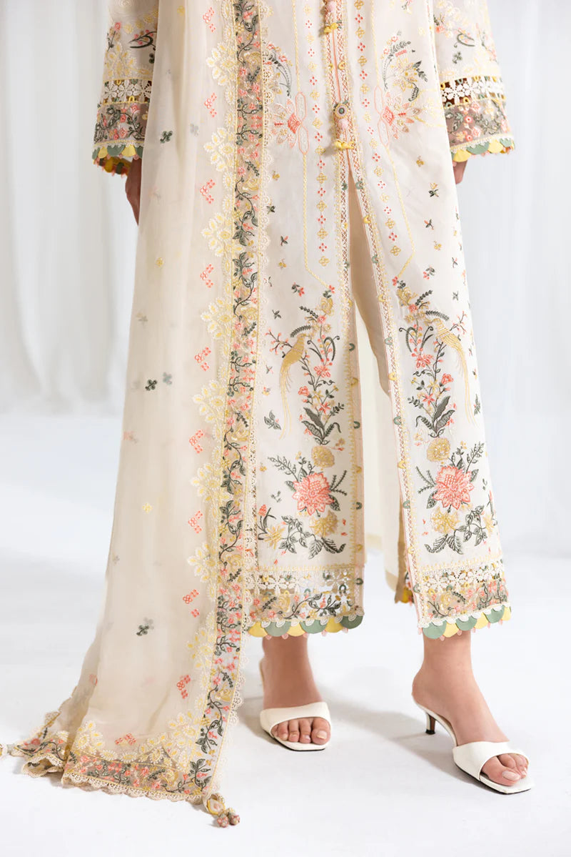 Model wearing ivory Qalamkar SB-01 Rina embroidered suit with pastel floral detailing, perfect for Eid and Pakistani luxury pret in UK.