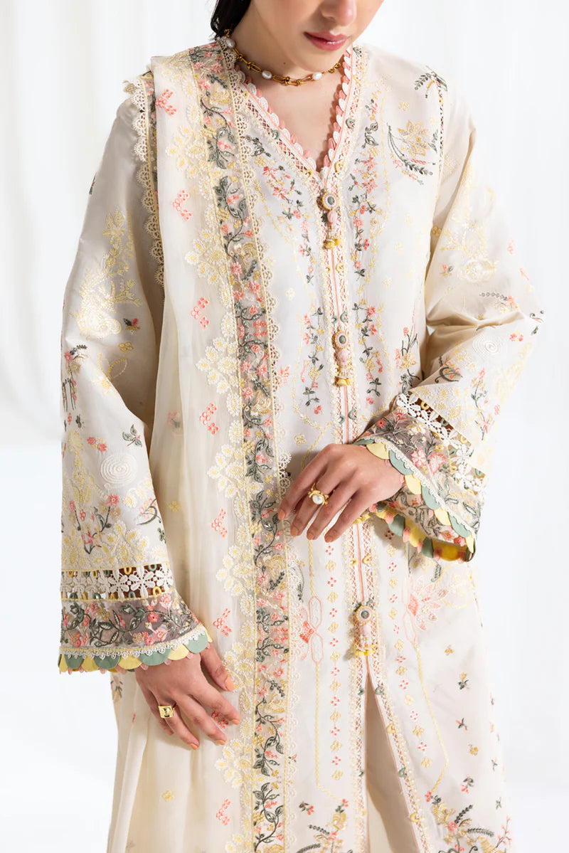 Model wearing ivory Qalamkar SB-01 Rina embroidered suit with pastel floral detailing, perfect for Eid and Pakistani luxury pret in UK.