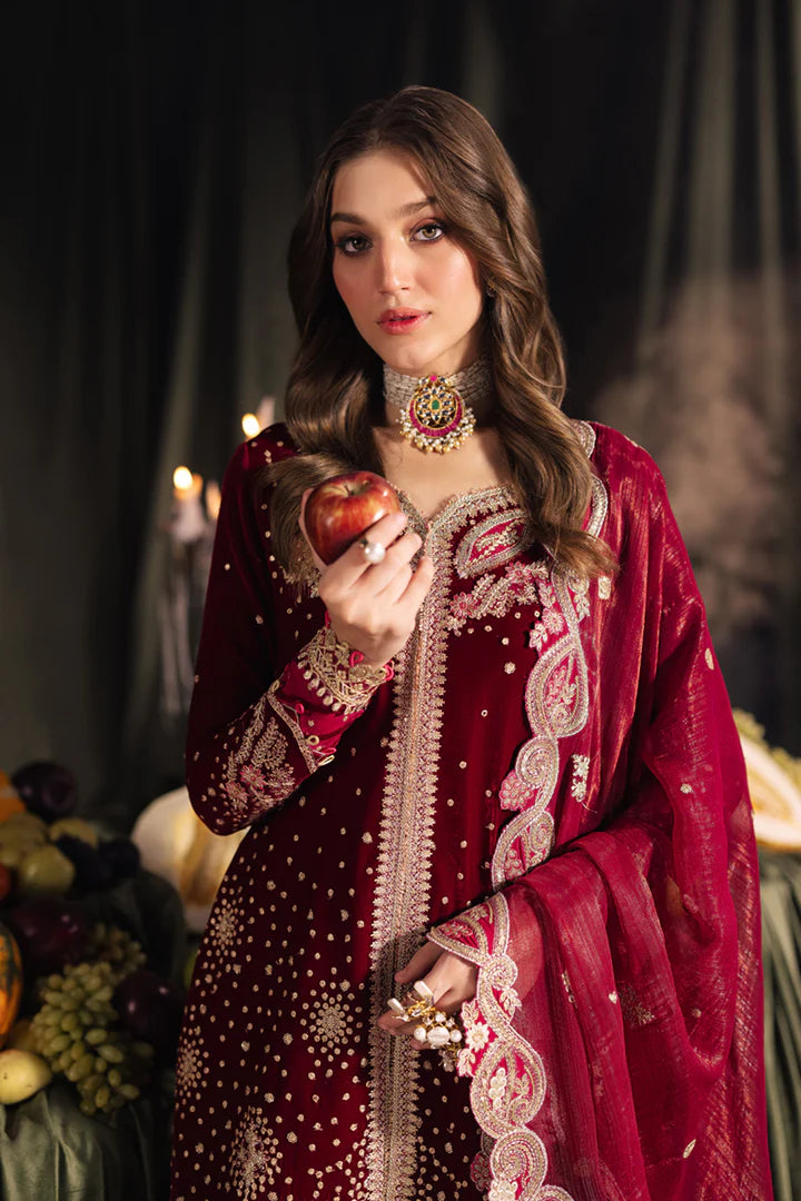 Model wearing Qalamkar Velvet Edit '24 BK-02 AMARA, a luxurious deep red velvet dress adorned with intricate embroidery, perfect for weddings. Available as Pakistani clothes online in the UK.