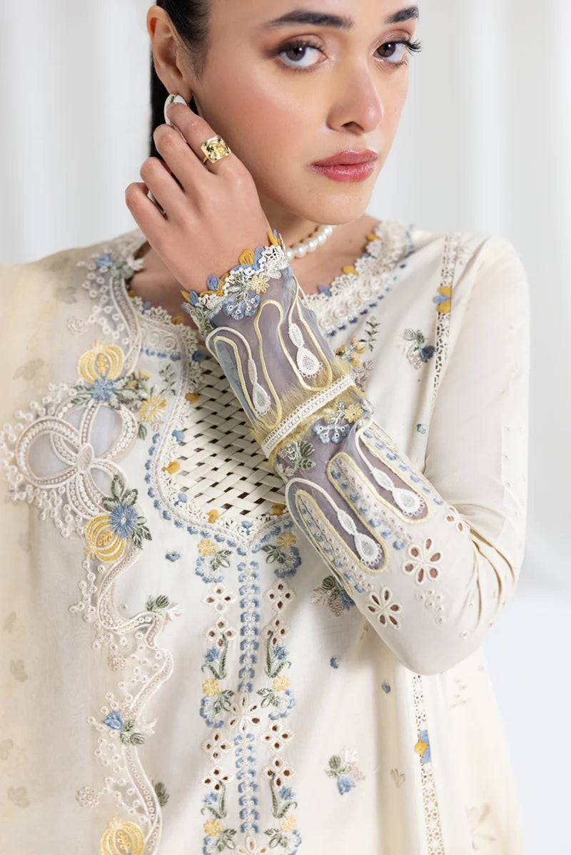 Model wearing ivory Qalamkar SB-09 Adeena embroidered outfit with sky blue accents, perfect for Eid and Pakistani luxury pret online in UK.