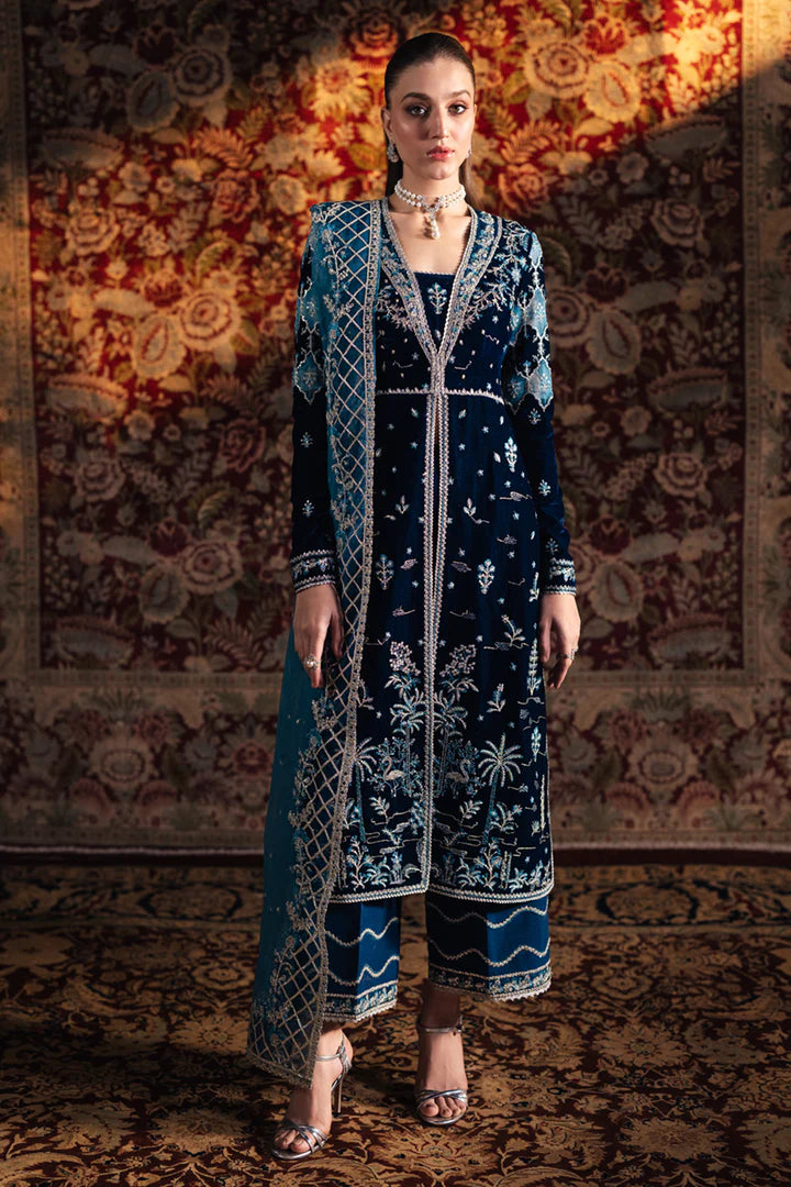 Model wearing Qalamkar Velvet Edit '24 BK-07 LIYANA, a deep blue velvet dress adorned with intricate embroidery, ideal for weddings. Available as Pakistani clothes online in the UK.