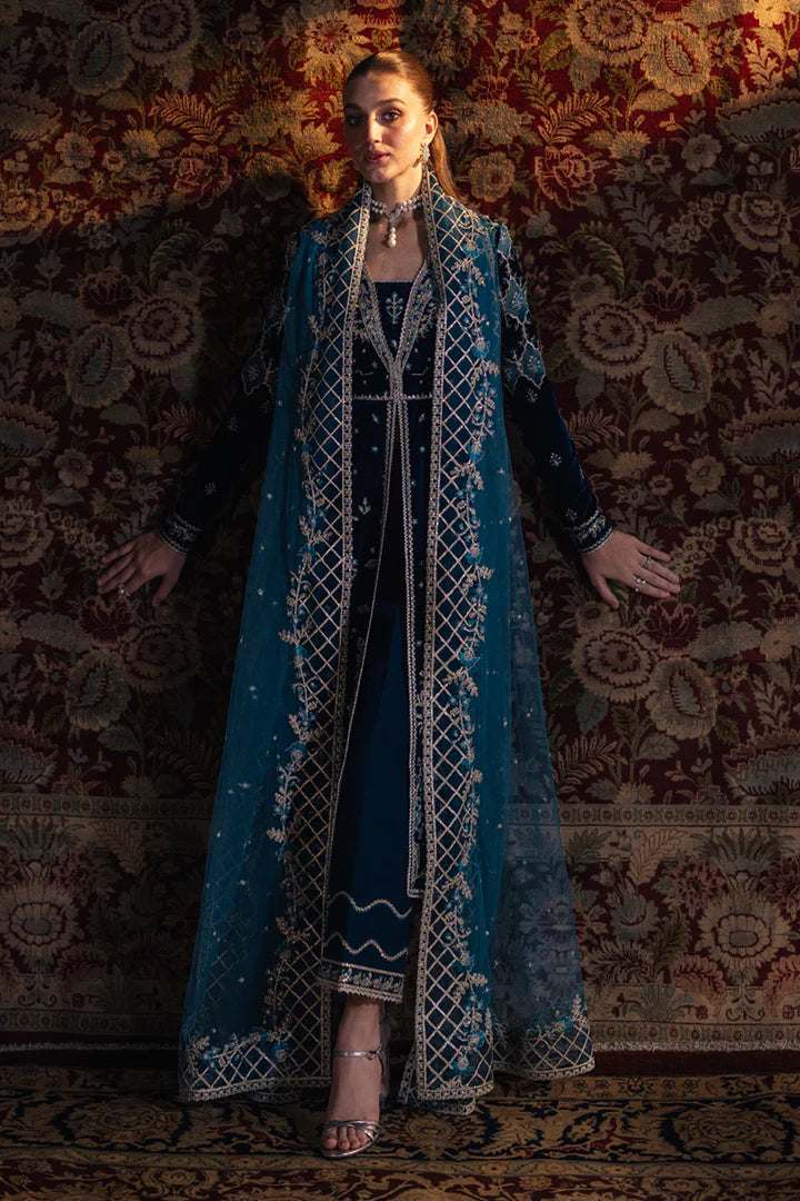 Model wearing Qalamkar Velvet Edit '24 BK-07 LIYANA, a deep blue velvet dress adorned with intricate embroidery, ideal for weddings. Available as Pakistani clothes online in the UK.