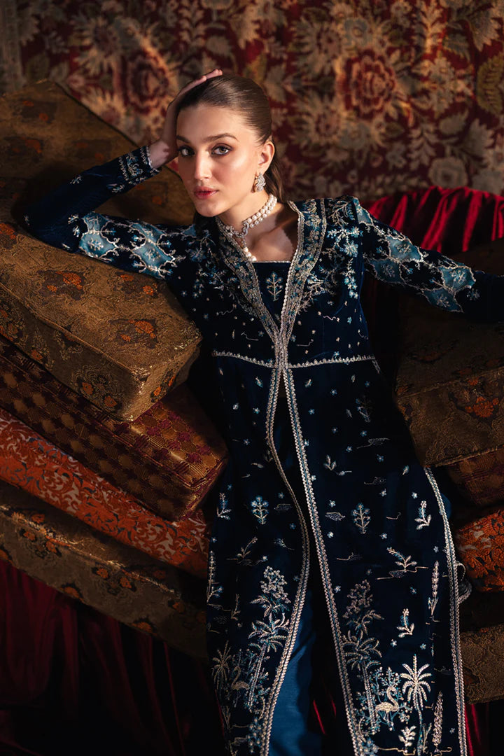 Model wearing Qalamkar Velvet Edit '24 BK-07 LIYANA, a deep blue velvet dress adorned with intricate embroidery, ideal for weddings. Available as Pakistani clothes online in the UK.