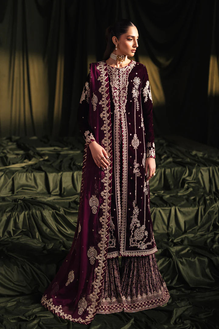 Model wearing Qalamkar Velvet Edit '24 BK-01 AMANI, a rich maroon velvet dress with intricate embroidery, ideal for weddings. Available as Pakistani clothes online in the UK.