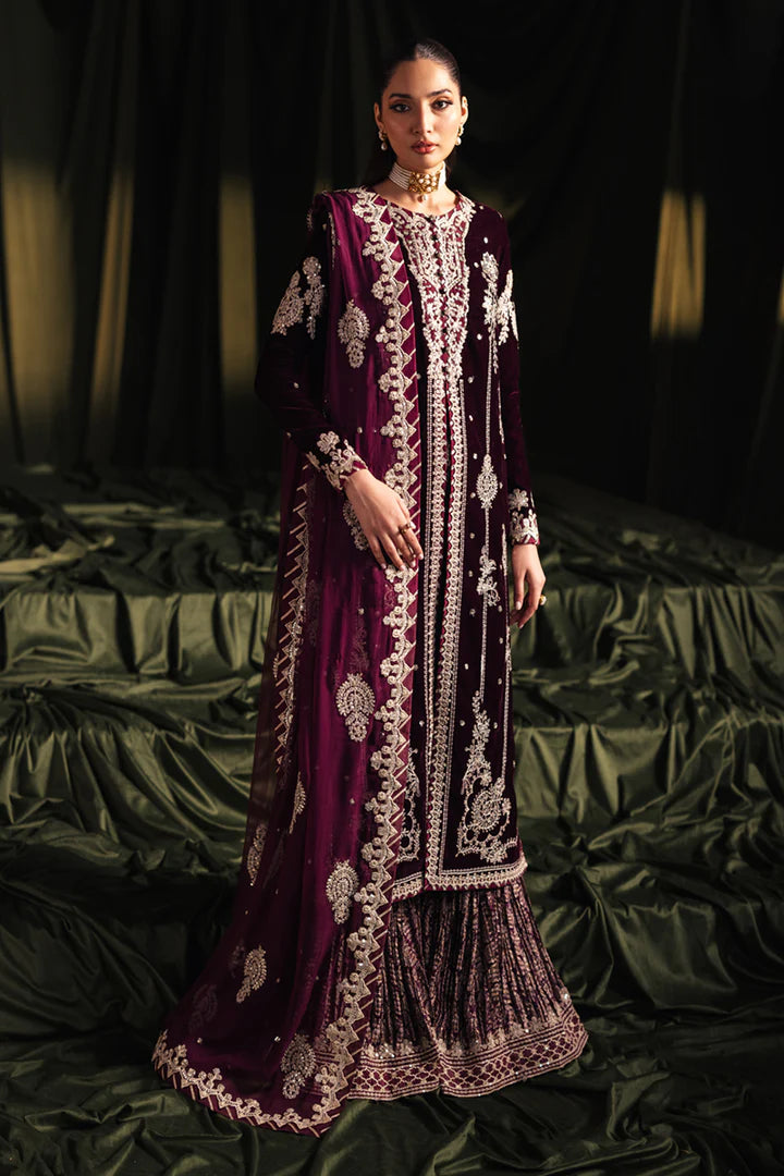 Model wearing Qalamkar Velvet Edit '24 BK-01 AMANI, a rich maroon velvet dress with intricate embroidery, ideal for weddings. Available as Pakistani clothes online in the UK.