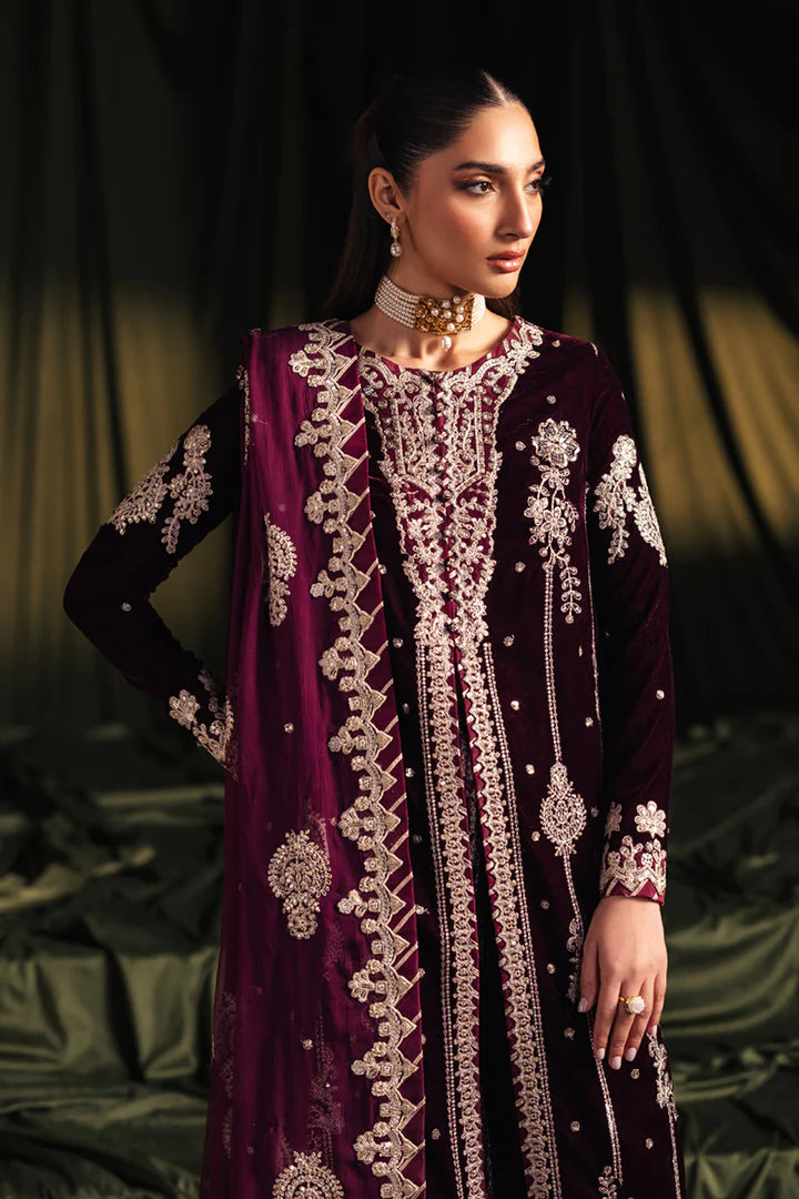 Model wearing Qalamkar Velvet Edit '24 BK-01 AMANI, a rich maroon velvet dress with intricate embroidery, ideal for weddings. Available as Pakistani clothes online in the UK.