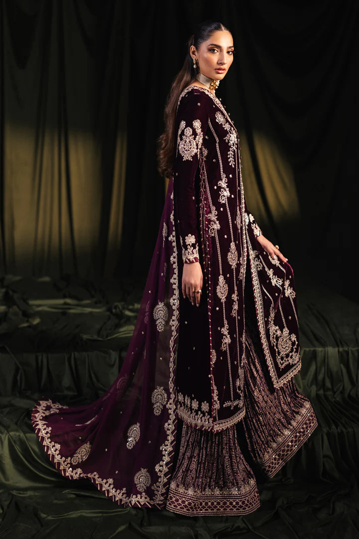 Model wearing Qalamkar Velvet Edit '24 BK-01 AMANI, a rich maroon velvet dress with intricate embroidery, ideal for weddings. Available as Pakistani clothes online in the UK.