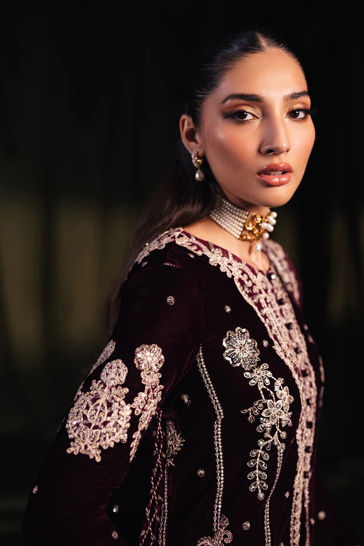 Model wearing Qalamkar Velvet Edit '24 BK-01 AMANI, a rich maroon velvet dress with intricate embroidery, ideal for weddings. Available as Pakistani clothes online in the UK.