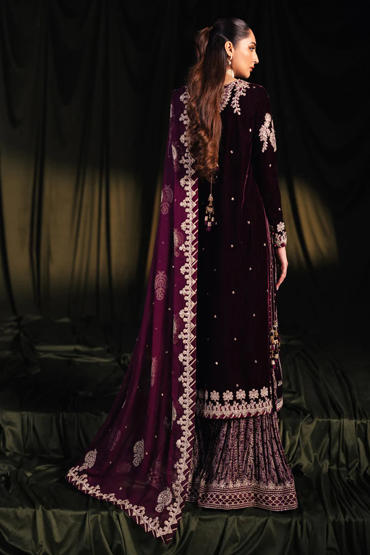 Model wearing Qalamkar Velvet Edit '24 BK-01 AMANI, a rich maroon velvet dress with intricate embroidery, ideal for weddings. Available as Pakistani clothes online in the UK.