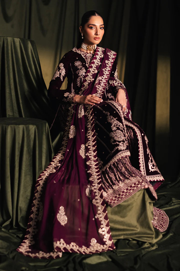 Model wearing Qalamkar Velvet Edit '24 BK-01 AMANI, a rich maroon velvet dress with intricate embroidery, ideal for weddings. Available as Pakistani clothes online in the UK.