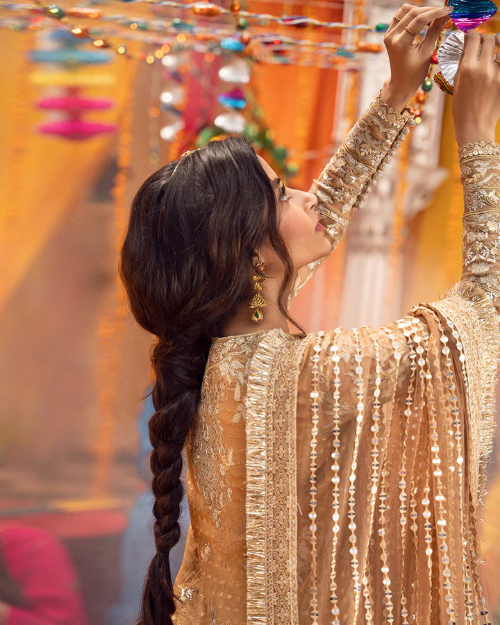 model wearing beige dress by Faiza Saqlain, Pakistani luxury pret ideal for online shopping in the UK
