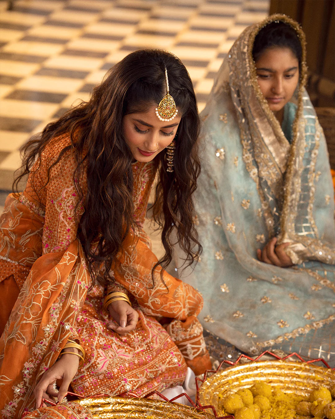 model wearing orange dress by Faiza Saqlain, Pakistani luxury pret ideal for online shopping in the UK