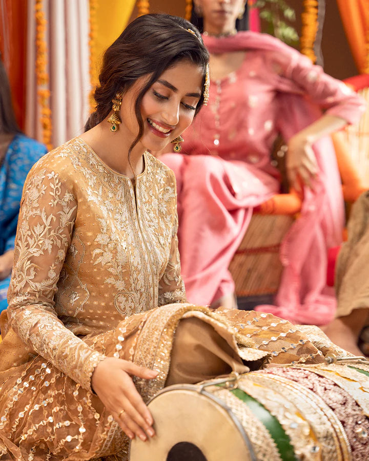 model wearing beige dress by Faiza Saqlain, Pakistani luxury pret ideal for online shopping in the UK